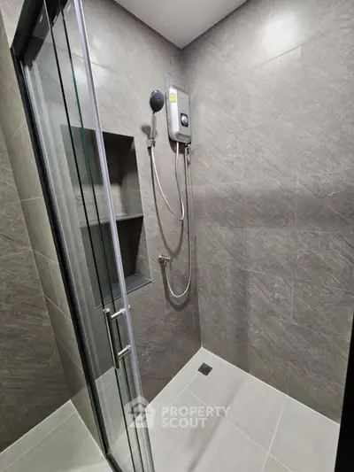 Modern bathroom with sleek shower design and gray tiles