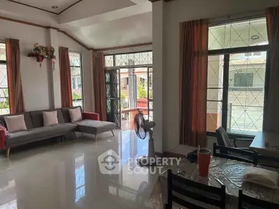 Spacious living room with modern decor and large windows for natural light