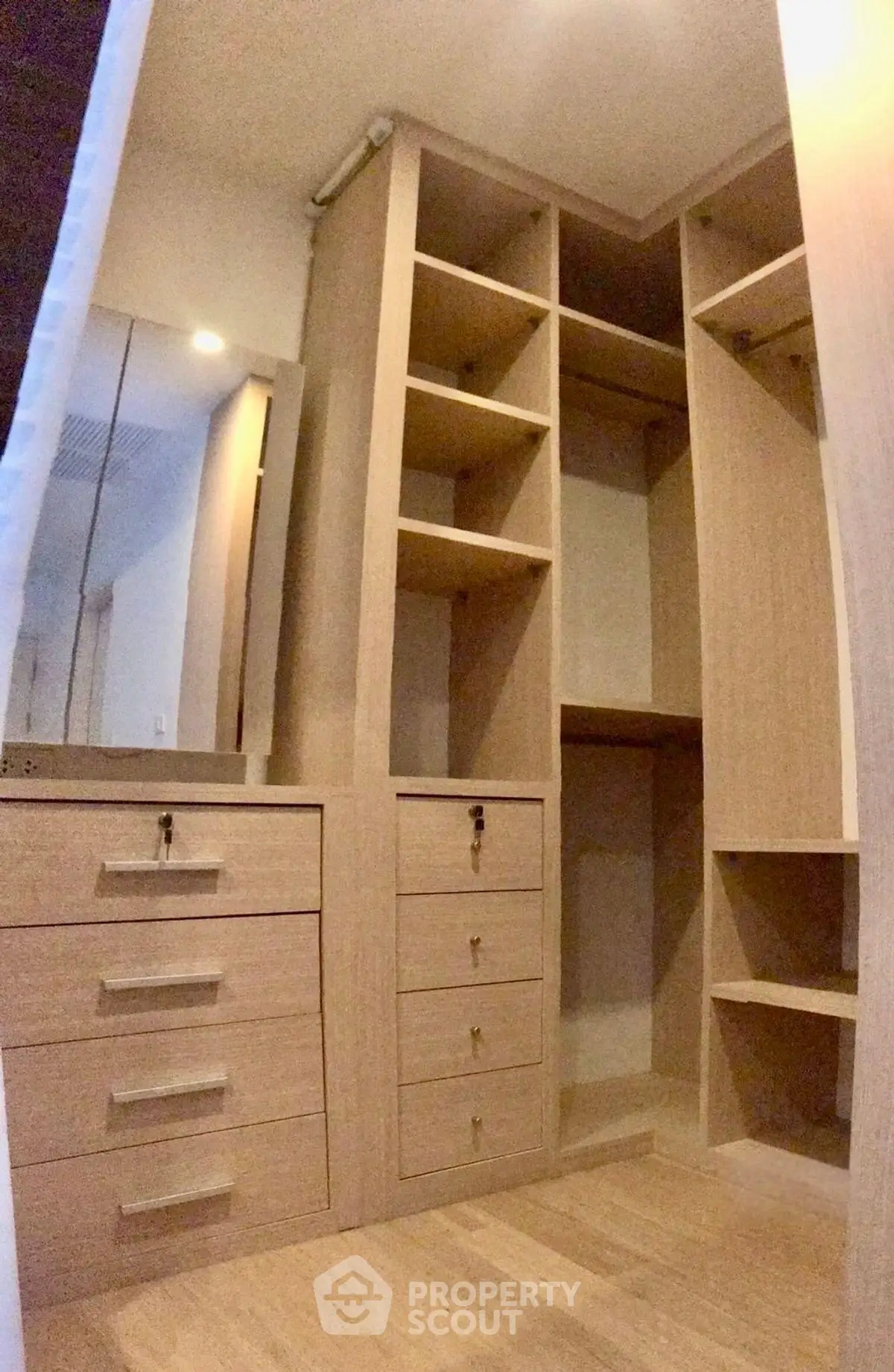 Spacious walk-in closet with ample storage and elegant wooden finish