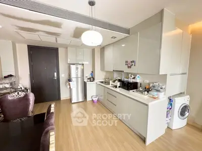 Modern kitchen with sleek cabinetry and integrated appliances in a stylish apartment.