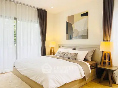 Elegant bedroom with modern decor and large windows offering natural light.