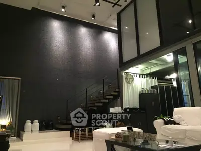 Luxurious modern living room with high ceilings and stylish staircase