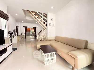 Spacious modern living room with elegant staircase and stylish furniture