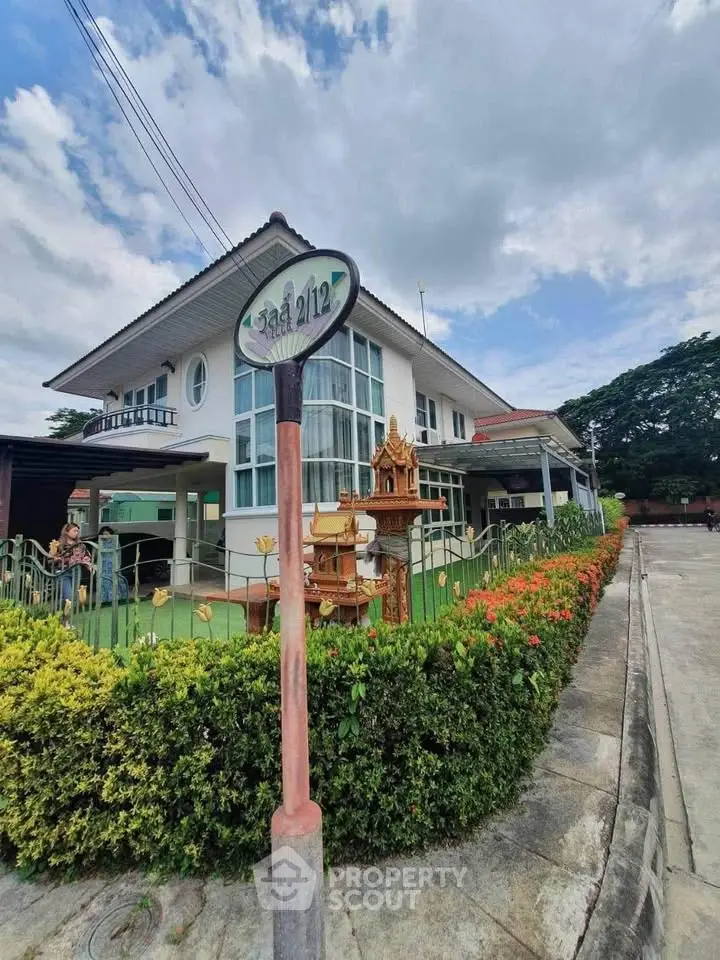 Charming two-story house with lush garden and traditional decor in a serene neighborhood.