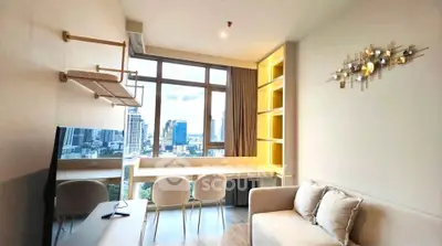 Modern living room with city view, stylish decor, and natural light in urban apartment.
