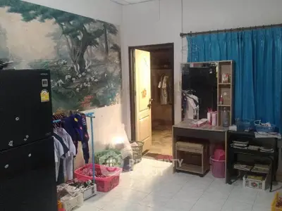 Cozy interior room with fridge, wall art, and organized storage solutions.