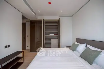 Modern bedroom with spacious walk-in closet and elegant design