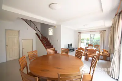 Spacious dining area with wooden furniture and natural light in modern home