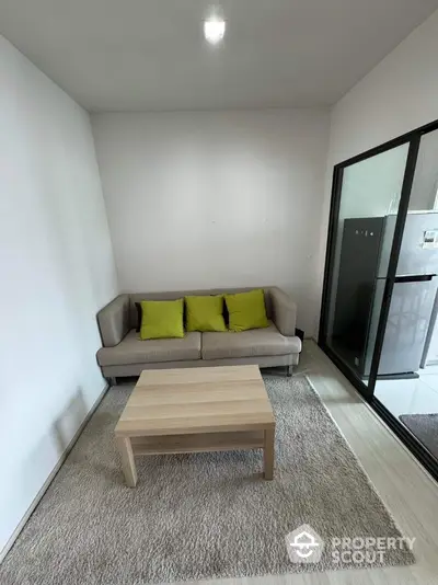 Cozy living room with modern sofa and coffee table, perfect for relaxation.