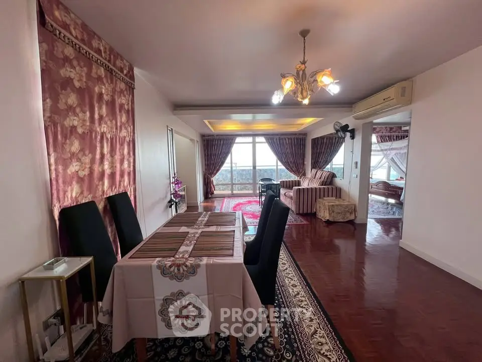 Elegant living room with dining area, featuring luxurious decor and stunning views.
