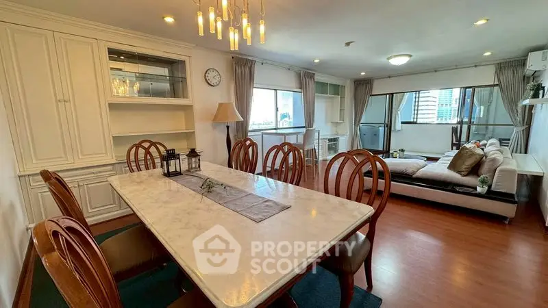 Spacious dining and living area with elegant decor and city view.