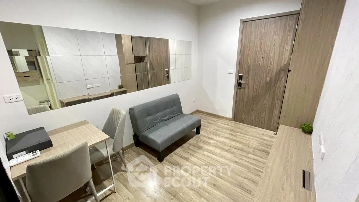 Modern compact living room with stylish furniture and wooden flooring