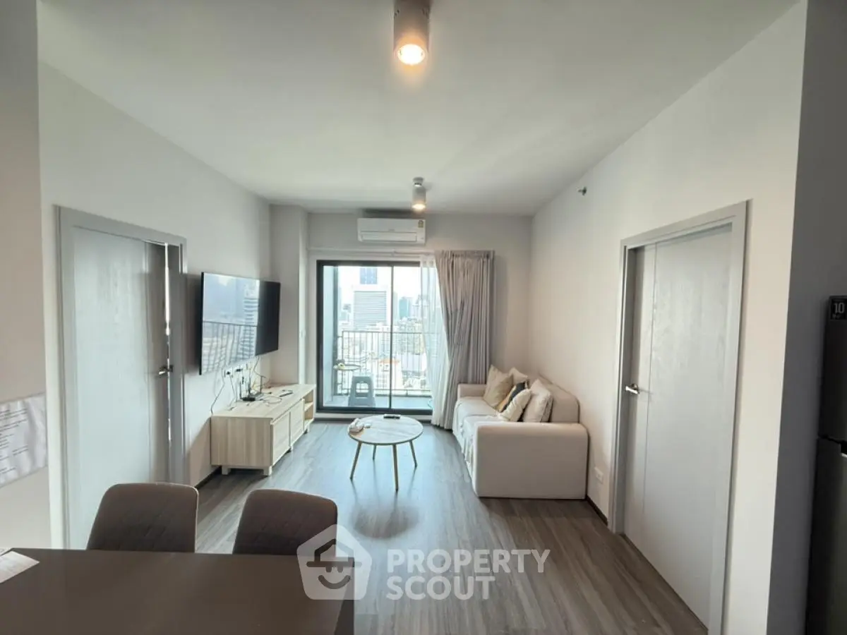 Modern living room with city view, stylish furniture, and natural light