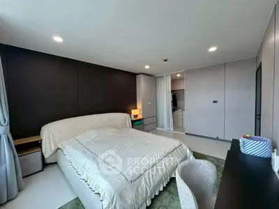 Spacious modern bedroom with elegant decor and ample natural light