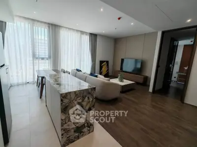 Luxurious modern living room with elegant decor and large windows offering natural light.