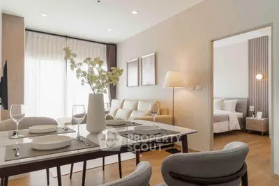 Modern open-plan living and dining area with elegant decor and natural light