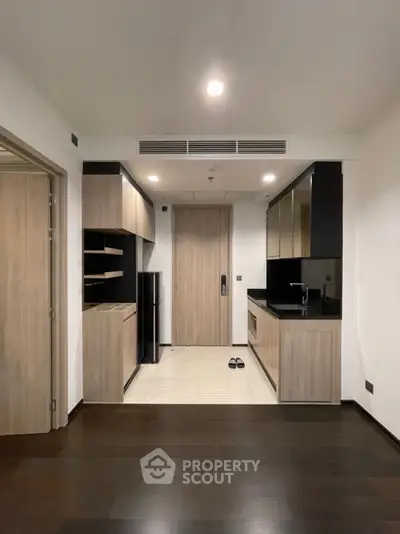 Modern kitchen with sleek cabinetry and compact design in a stylish apartment.