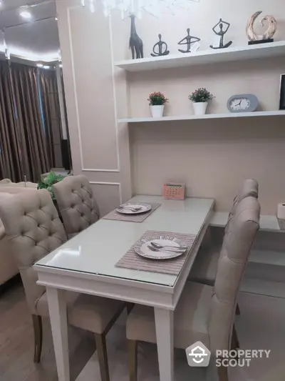 Elegant dining area with plush chairs and modern decor in a stylish apartment