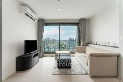 Modern living room with city view, featuring sleek furniture and large windows.