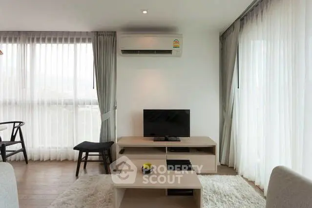 Modern living room with sleek furniture and large windows for natural light