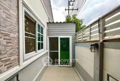 Charming small outdoor patio with privacy fence and sliding glass door entry.
