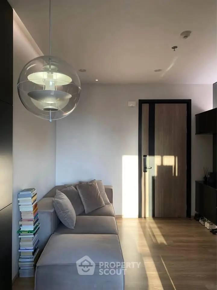 Modern living room with stylish pendant light and cozy sofa, perfect for relaxation.