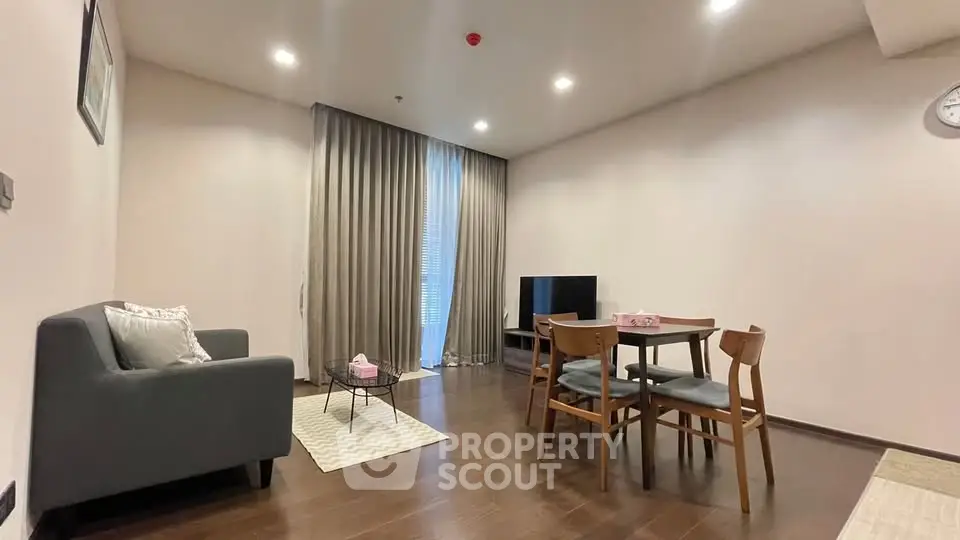 Spacious living room with modern furniture and elegant decor in a cozy apartment.