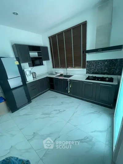 Modern kitchen with sleek cabinetry and gas stove in stylish home