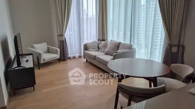 Modern living room with elegant furniture and large windows in a high-rise apartment.