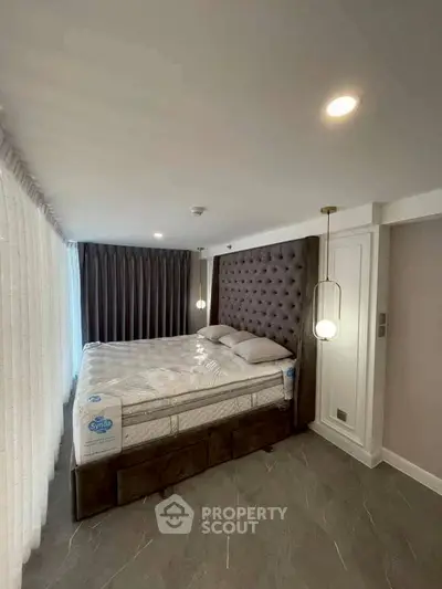 Luxurious bedroom with elegant lighting and plush bed in modern apartment