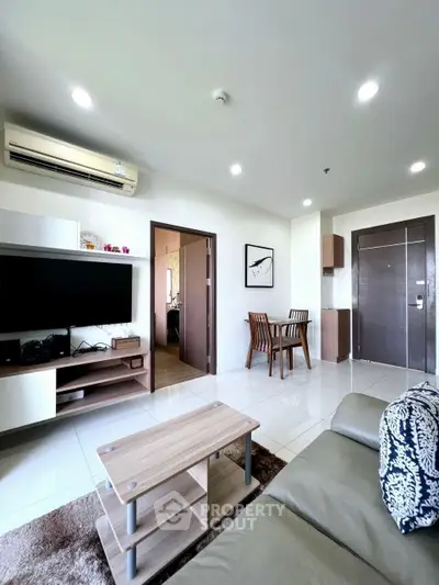 Modern living room with sleek furniture and open layout, featuring a cozy dining area and stylish decor.