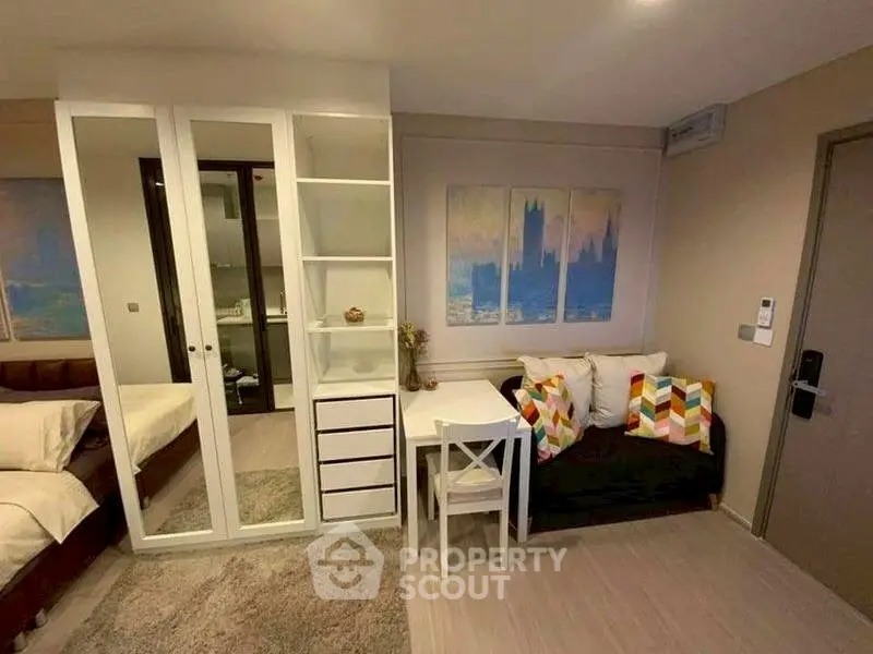 Cozy studio apartment with modern decor and compact living space.