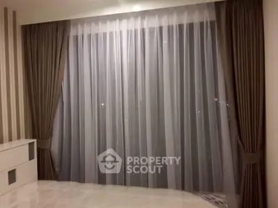 Elegant living room with floor-to-ceiling curtains and modern decor