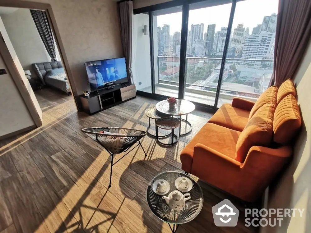 Sunlit spacious living room with modern orange sofa, stylish coffee tables, and a panoramic city view through large windows, perfect for urban living.