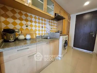 Modern kitchen with washing machine and stylish backsplash