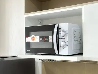 Modern kitchen with a sleek microwave oven in a stylish cabinet.