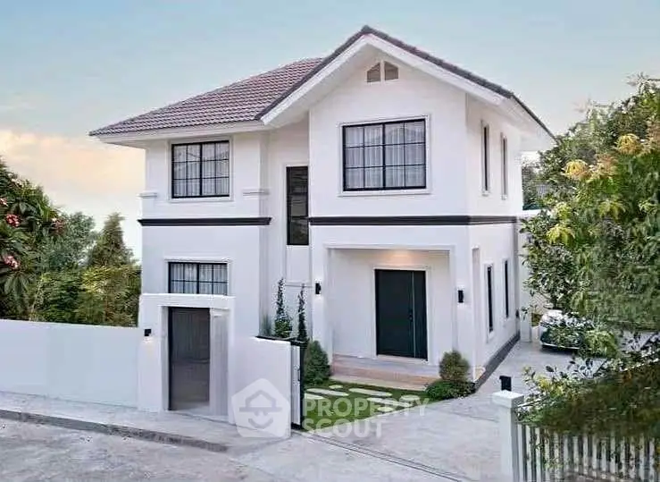 Modern two-story house with sleek design and lush greenery, perfect for family living.