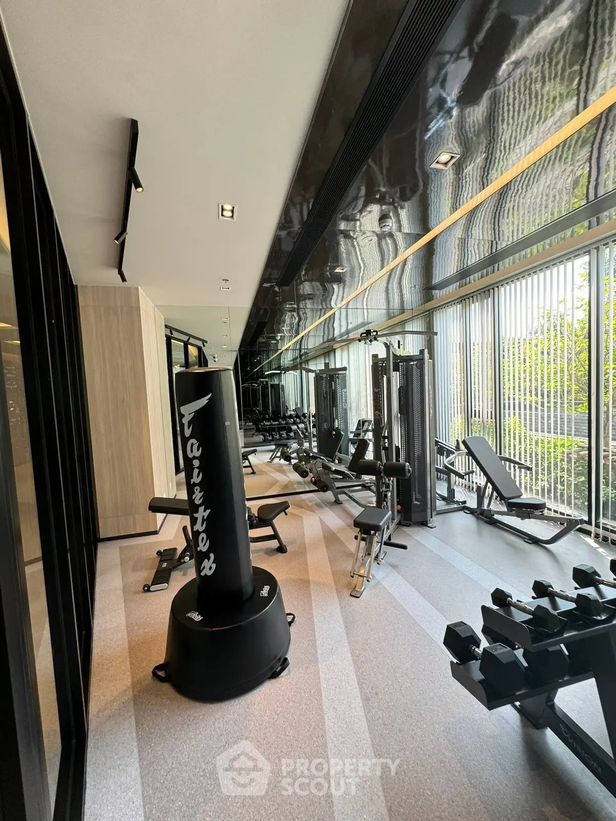 Modern gym with state-of-the-art equipment and floor-to-ceiling windows