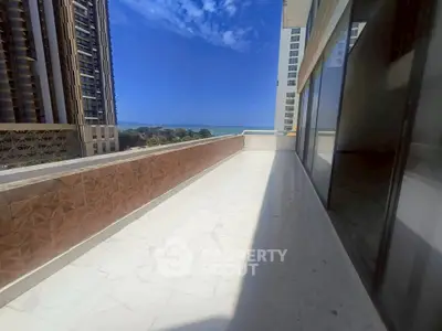 Spacious balcony with ocean view in modern high-rise building