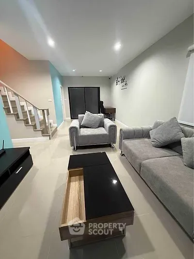 Modern living room with stylish gray sofas and sleek coffee table