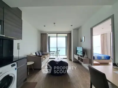 Modern living room with ocean view, open layout, and stylish decor