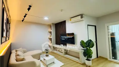 Modern living room with stylish decor, cozy sofa, and wall-mounted TV, perfect for relaxation and entertainment.