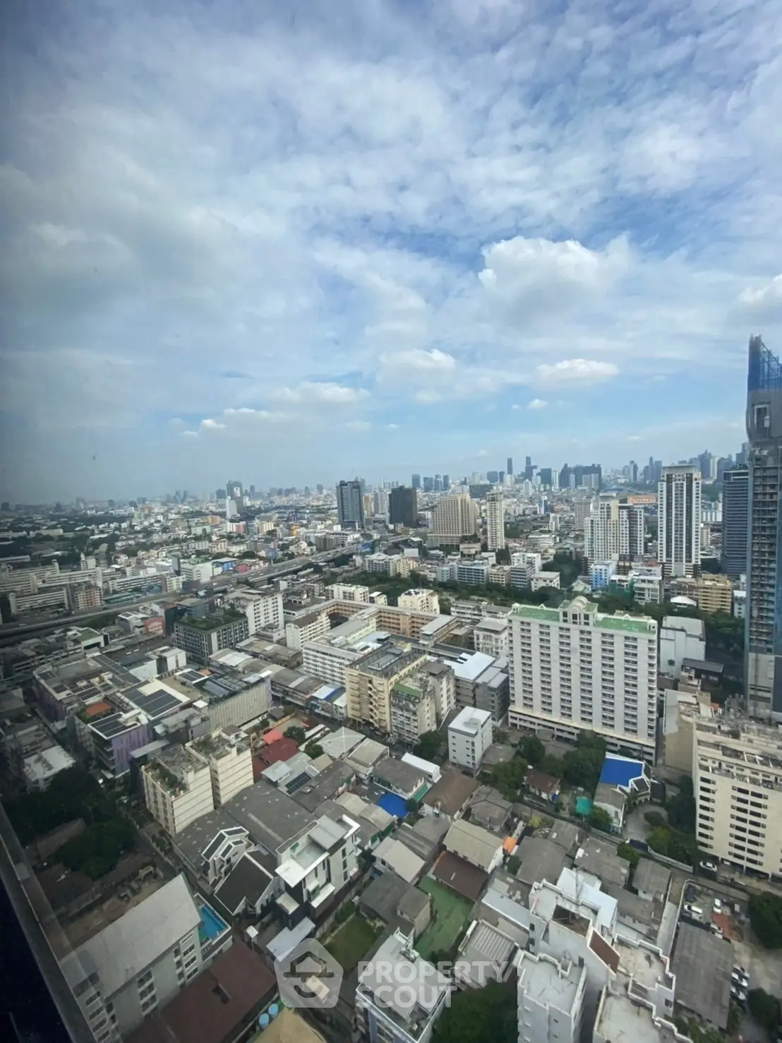 Stunning cityscape view from a high-rise building showcasing urban skyline and expansive horizon.