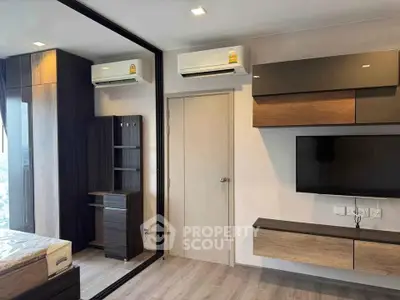 Modern bedroom with sleek design, featuring mirrored wardrobe, wall-mounted TV, and dual air conditioning units.