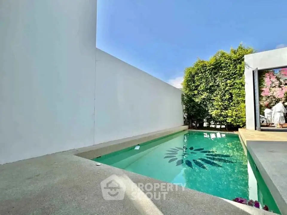 Luxurious private pool area with modern design and lush greenery, perfect for relaxation and entertainment.