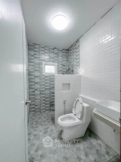 Modern bathroom with sleek tile design and contemporary fixtures.