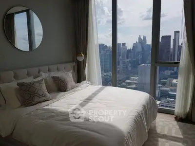 Luxurious bedroom with stunning city skyline view, featuring elegant decor and large windows for natural light.