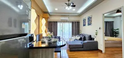Modern open-plan living room with sleek kitchen and cozy seating area
