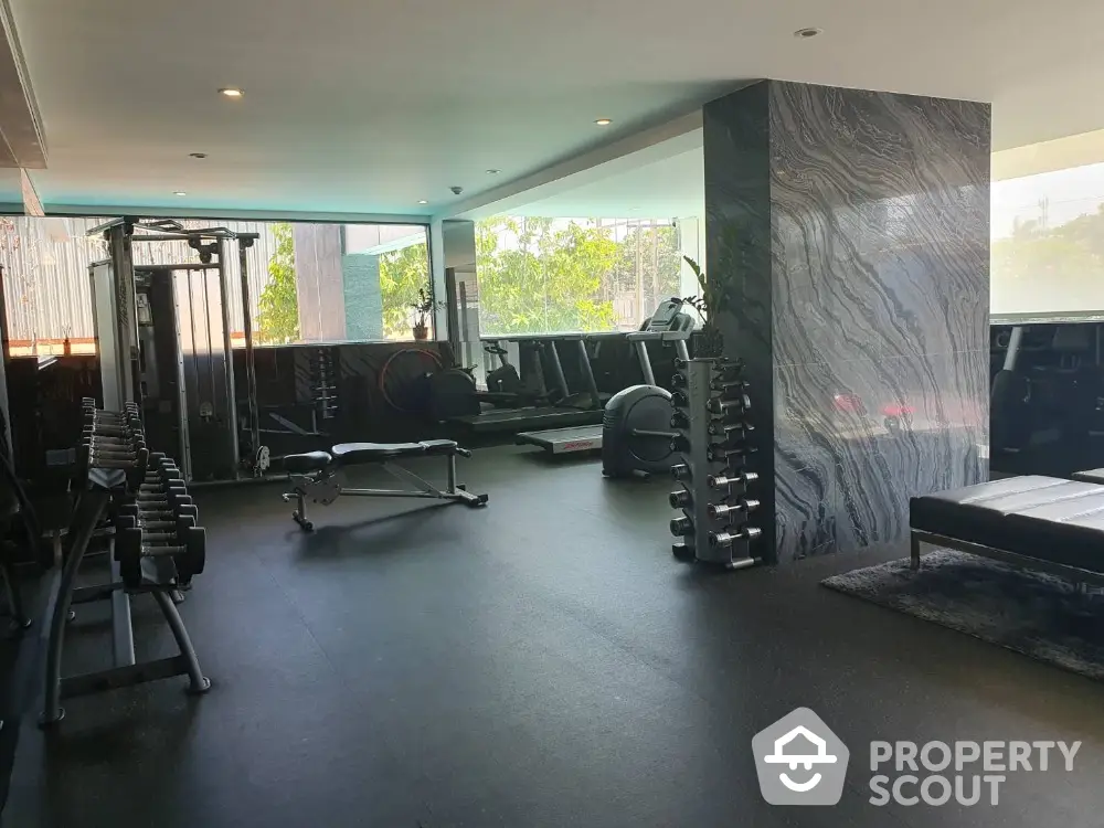 Spacious modern gym with state-of-the-art equipment and natural light