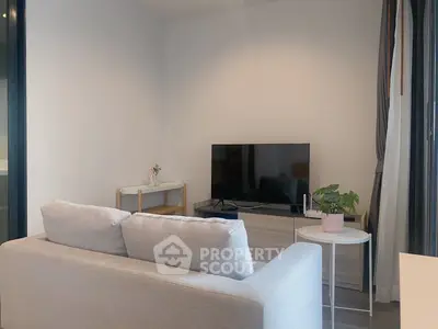 Modern living room with sleek TV setup and cozy gray sofa